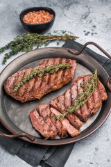 Roast Top blade steak, grilled beef shoulder meat. grey background. top view