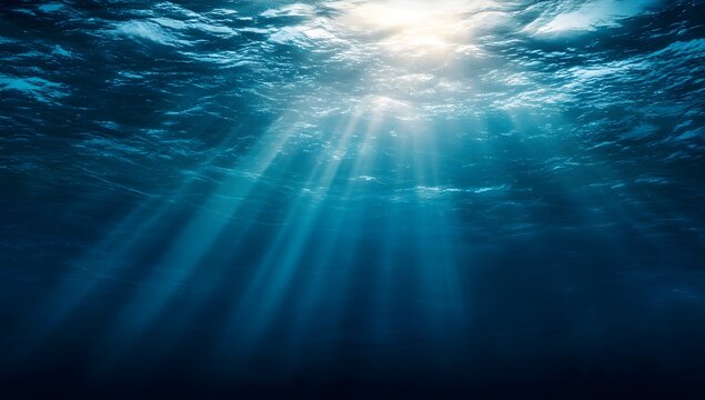 Sunlight piercing through deep blue ocean water creating beautiful underwater light rays
