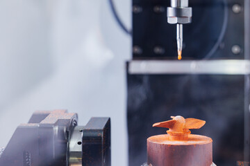 Precision cnc milling machine crafting intricate metal design with cutting tool