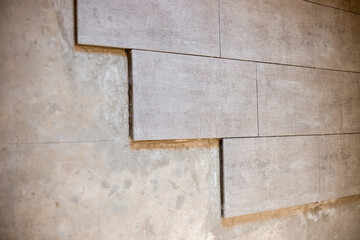 Laying large format ceramic tiles on a concrete floor during renovation