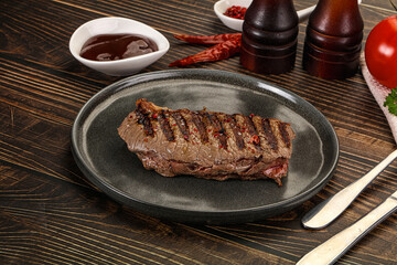 Grilled beef striploin steak with sauce