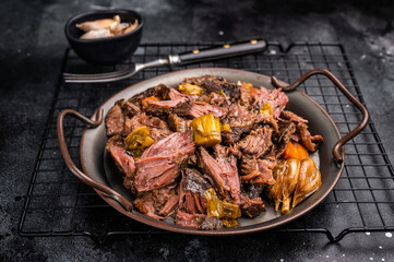 Braised Beef Cheek Stew, traditional Slow cooked meat. black background. top view