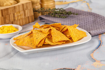Corn nachos chips with cheese dip