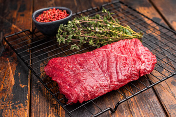 Raw flank steak, beef meat ready for BBQ. wooden background. top view