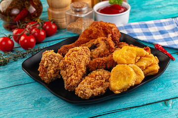 Golden crispy fried chicken mix - wings, drumsticks, nuggets and strips