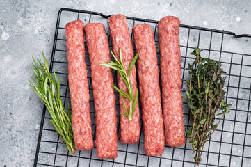 Raw beef and lamb meat kebabs sausages, kofta kebab. grey background. top view