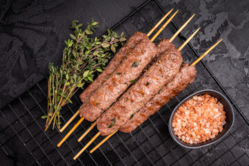 Grilled Cevapcici skewers, Cevapi sausages from mince beef and pork meat. black background. top view