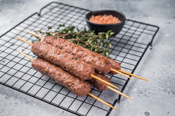 BBQ Roasted beef and lamb meat kebabs sausages, kofta kebab. grey background. top view