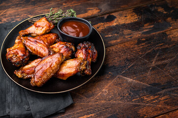 Deliciously sticky teriyakis sauce chicken wings, bursting with flavor, perfect for sharing at festive occasions or family dinners. wooden background. top view