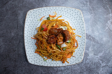 Savory Beef Noodles with Vegetables and Sauce on a Plate top view of asian food