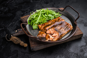 Roasted Teriyaki salmon fillet with salad. black background. top view
