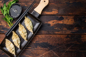 Traditional Chinese Jiaozi Dumplings with pork meat and vegetables. wooden background. top view