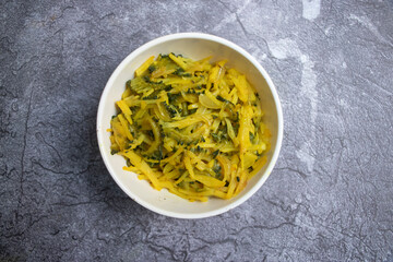 Healthy Mixed Vegetable Bhaji in bowl with Bitter Gourd and onion top view of A Traditional South...