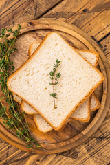 Ready for toasts Slices of wheat bread. wooden background. top view