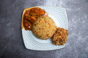 Savory Chinese Cuisine Spicy Chicken Curry, Fried Rice, and Crispy Drumstick served in plate top view of fast food
