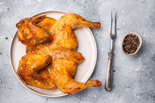 Roasted Spatchcock Chicken, poultry meat. grey background. top view