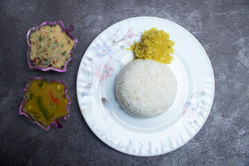 Vegetarian set meal with rice, mashed potato, and dal curry in plate top view of South Asian food