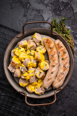 Currywurst sliced Sausages with curry sauce, wurst in steel plate. black background. top view