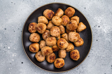 Savory meatballs, meat dumplings garnished with fresh herbs. A delightful addition to any meal, bringing warmth and satisfaction to the table. grey background. top view