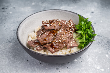 Delectable yakiniku feast, featuring a variety of marbled beef cuts and rice. A culinary journey that captures the essence of Japanese grilling traditions. grey background. top view