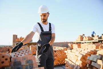 Construction worker in uniform and safety equipment have job on building