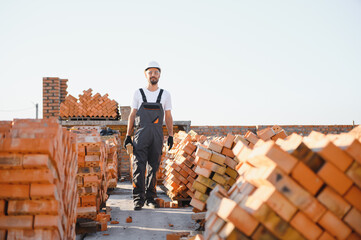 Construction worker in uniform and safety equipment have job on building