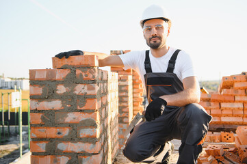 Construction worker in uniform and safety equipment have job on building