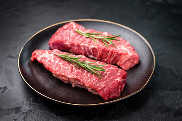 High-quality Denver cut, featuring a perfect balance of fat and meat steak. A great choice for those seeking a flavorful and juicy steak experience. black background. top view