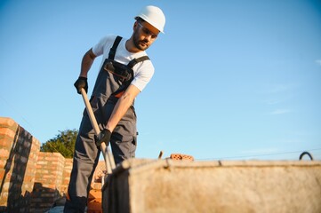 Indian Construction worker in uniform and safety equipment have job on building