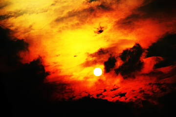 Sun partially obscured by clouds