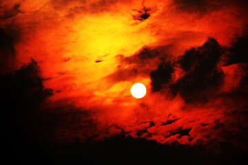 Sun partially obscured by clouds