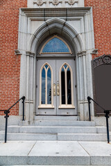Elegant Double Door with Carved Panels and Stone Arch in Downtown