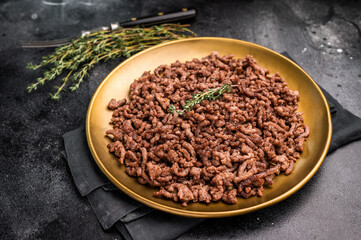 Roast and Fried mince meat, fresh cooked ground meat in a plate. black background. top view