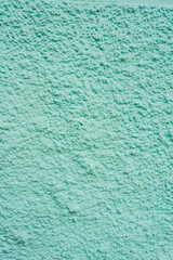 Pared rugosa pintada en color turquesa pastel como fondo abstracto