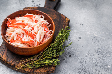 Fresh Crab meat, crabmeat in wooden bowl. grey background. top view © Mironov