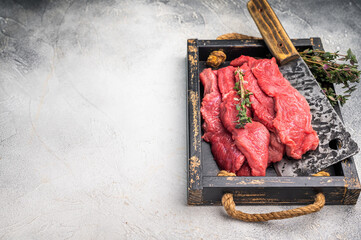 Raw horse meat slices in a wooden tray, showcasing its appealing color and texture, ready for...