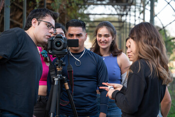 Filming Behind the Scenes Crew and Model Reviewing Footage