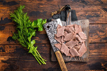 Corned sliced beef meat on wooden cutting board. wooden background. top view