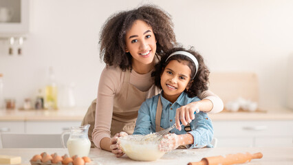 Baking Is Fun. Portrait Of Smiling African American Woman And Girl With Dirty Faces Mixing Dough...