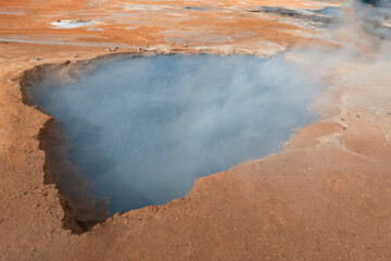 Hverir Geothermal Area with mud pots and smoky fumeroles (steam vents) 
