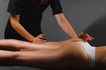 Masseur doing massage on woman body in the spa salon. Beauty treatment concept