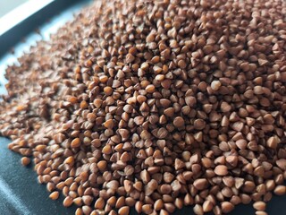 Buckwheat, superfood, healthy vegetarian food. Dry grits. Grains. Close-up