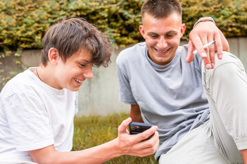 young people sitting on a bench in the park, using smartphones and browsing social media while...