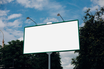 Blank Outdoor Billboard Mockup Against Blue Sky and Green Trees