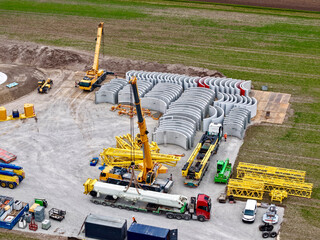 Construction of a large crane for the construction of a wind turbine tower, aerial photograph,...
