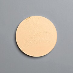 Light peach-toned cosmetic disc on gray background