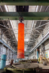 Hardening of pipe in special furnace, hot iron pipe on crane