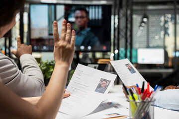 Confident job seeker joining remote interview with HR using video call tech, evaluating the resume,...