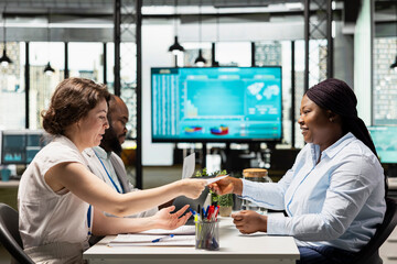 Female applicant and hiring staff asking questions in an interview meeting, discussing about career opportunity for onboarding into the department workforce. Head hunting for development.