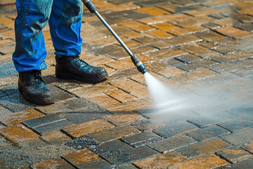 High-Pressure Washing Paver Patio Surfaces for Outdoor Cleaning and Maintenance